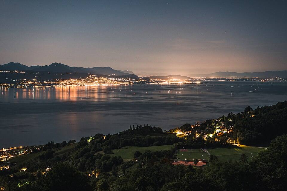 View on Évian-les-Bains at nighttime from Lavaux with Lake Geneva — travel photo of Lavaux, Geneva