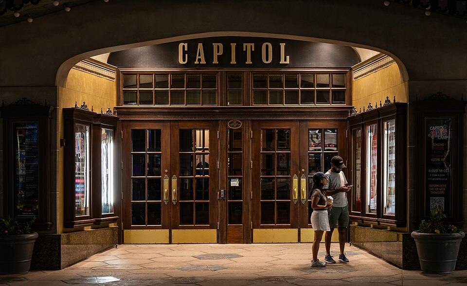 Couple viewing upcoming shows, Capitol Theatre, Windsor, Ontario — travel photo of Ontario