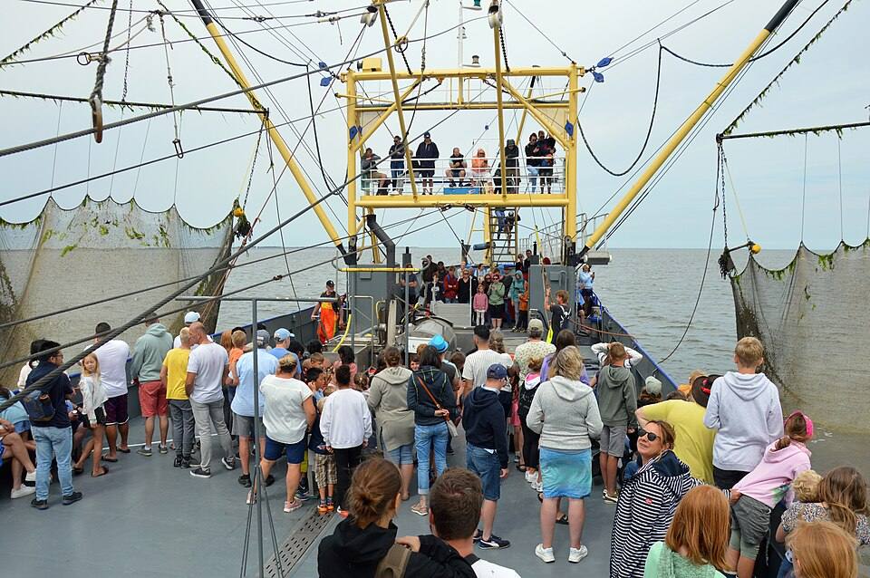Tourists on a shrimp trawler on the Wadden Sea off Texel — travel photo of Texel & the Wadden, The Netherlands