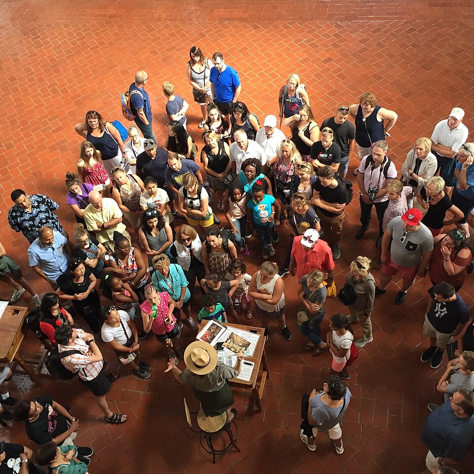 Ellis Island Immigration Museum, part of Statue of Liberty National Monument- A crowd listens to a ranger in the Great Hall (6912ec0b-f856-4eb7-b735-4d1c98321974) — travel photo of Statue of Liberty Museum, Statue of Liberty & Ellis Island