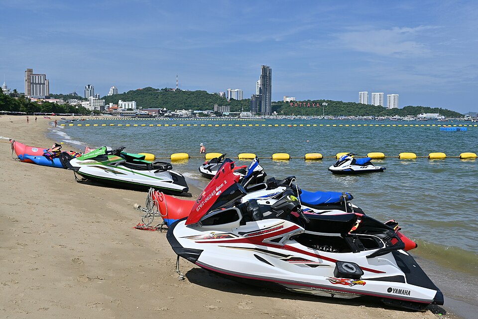 DFC Jet skis lined up on a sunny beach ready for a day of fun on the water with the city skyline in the background — travel photo of Swimming water, Sandy Bay